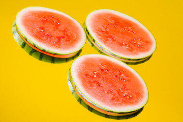 Fresh and juicy watermelon fruits on yellow colorful background. Tasty melon slices in the summer....