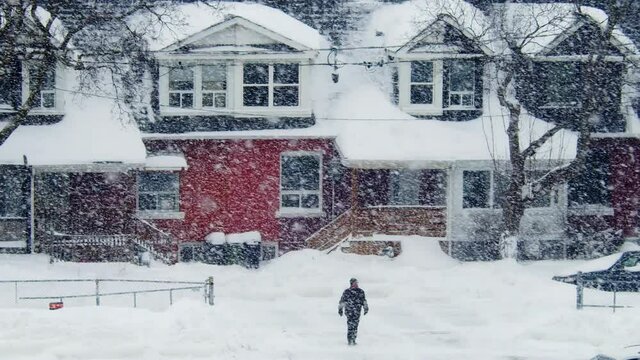Establishing shot of residential homes after a snow storm in Toronto. 4K footage.