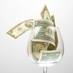 dollar banknotes money lies in an empty wine glass. business in the wine industry. alcohol marketing