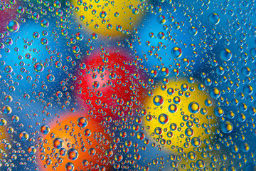 abstract colored balls of oily liquid on a blurred background