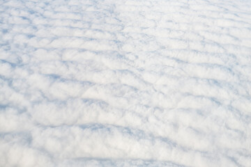 Flying above Reykjavik, Iceland with cloudscape aerial high angle view above of abstract cloudy landscape sky and pattern of white fluffy clouds from airplane