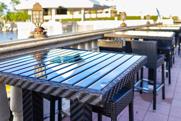 Naples, Florida nobody empty outdoor restaurant cafe sunny sunset sunlight by marina dock wharf...