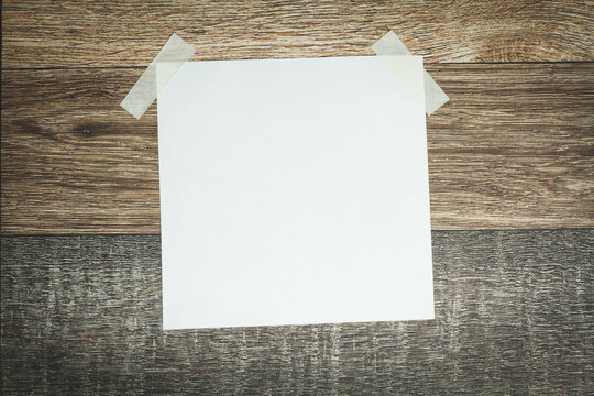 A white sheet of paper is glued with tape. Announcement template.