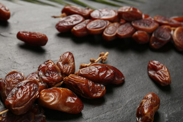 Tasty sweet dried dates on black table, closeup