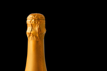 close-up of an unopened bottle of champagne in foil for cut out and design, alcoholic background