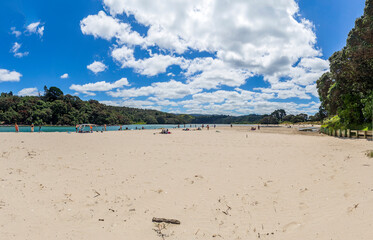 People enjoying the sunny day at Otahu Point Reserve (Pohutukawa Drive) in Whangamata, New Zealand