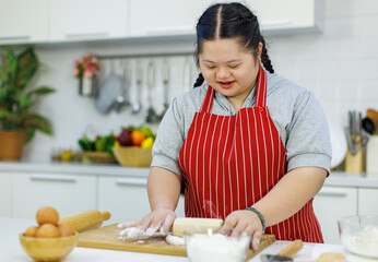 Asian young chubby down syndrome autistic autism girl pastry chef model wearing red apron standing...