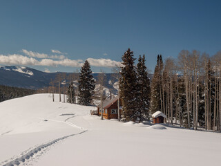 Skiing down to a mountain cabin in winter