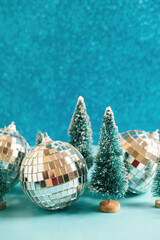 Christmas festive background with christmas toy trees and disco balls. Abstract glitter blurred background shiny blue ai aqua. Bright sparkling wallpaper with bokeh texture.