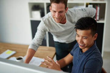 Young visionaries in design. High angle shot of two designers working together on a project in an office.