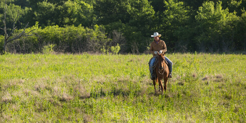 cowboy riding a horse on the ranch