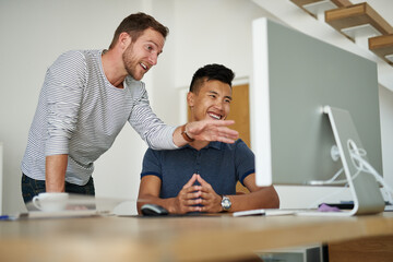 Coming up with something new. Cropped shot of two designers working together on a project in an office.