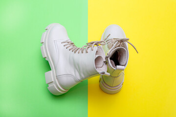 Female winter boots on high soles on a colored background, top view