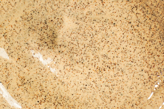 Texture of organic white scrub with Exfoliating coffee particles. Close up