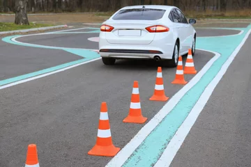 Wandcirkels plexiglas Modern car on driving school test track with traffic cones © New Africa
