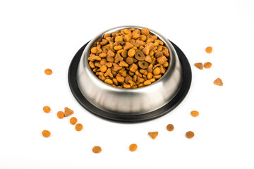Food for cats and dogs in a metal bowl is isolated on a white background.