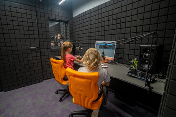 Kids monitoring the sound quality in the studio