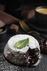 Delicious fresh fondant with hot chocolate and mint on slate plate, closeup
