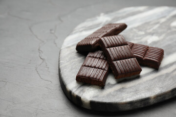Marble board with delicious and healthy hematogen on black table. Space for text