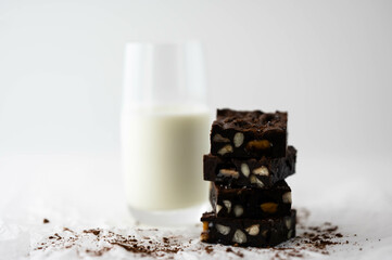  stack of brownies (soft focus) with glass of milk