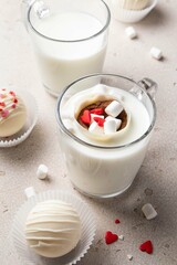 Hot cocoa chocolate ball bomb with marshmallow. Holiday winter drink. Handmade Valentines day present. Selective focus.