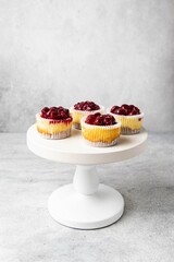Mini cheesecake with cherry jam. One bite dessert. Tiny cheesecakes with berry. Valentine homemade present. Selective focus.