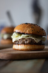 Homemade burgers with beef and cheese, homemade buns. Front view.
