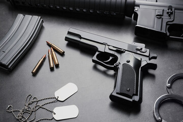 Composition with gun and bullets on stone table