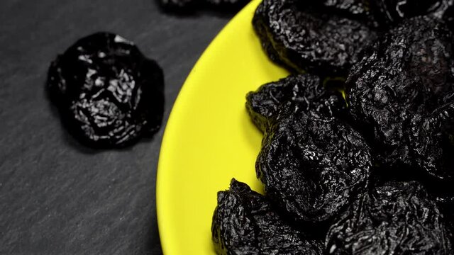 Dried plums (prunes) rotation background. Close up