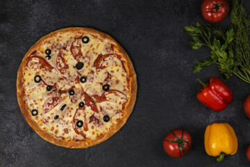 pizza with tomatoes on dark 