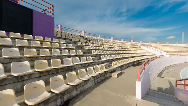 Stadium, Red Seats On Stadium Steps Bleacher With Spot Light Pole, Copy Space For Text.