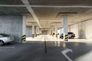 Blurred view of open parking garage with cars on sunny day - obrazy, fototapety, plakaty