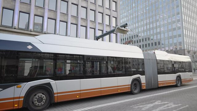 Electric bus at the charging point downtown. Public transport - Battery charged, pantograph descends