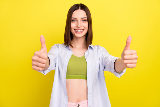 Photo of cute brunette young lady show thumb up wear green top blue shirt isolated on yellow color background