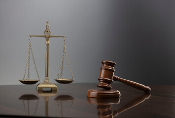 Law symbols composition. Law and justice concept.  Gavel and scale on gray background.