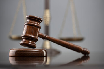Law symbols composition. Law and justice concept.  Gavel and scale on gray background.