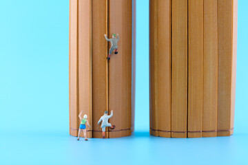 Miniature creative climber climbs traditional bamboo slips