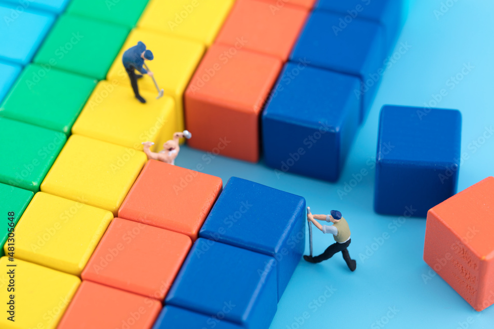 Wall mural Miniature scene workers remove building blocks to open up roads