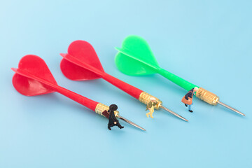 Miniature creative dart pointing to strive to achieve