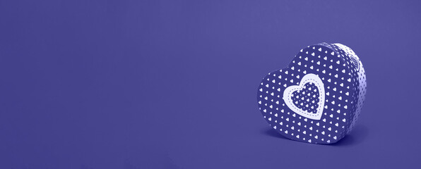 Mockup of a box in the shape of a heart on a very peri background. Closeup with copy space