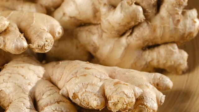 Whole ginger root on close up rotating 4K