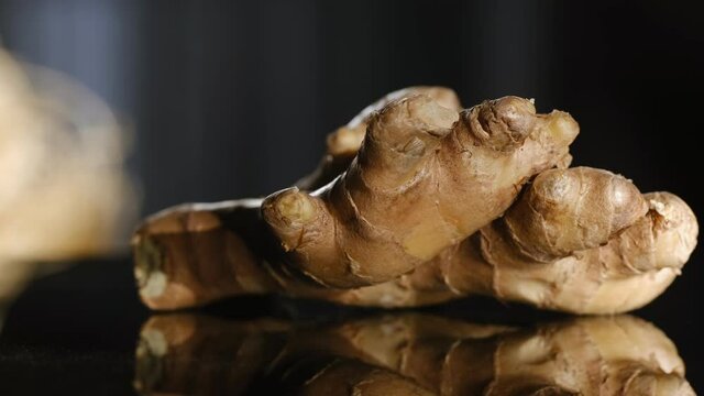 Whole ginger root on close up rotating 4K