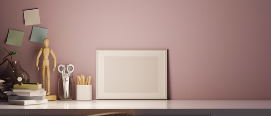 Mockup of an empty picture frame on worktable over pink wall background.