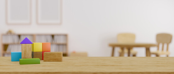 A copy space on wooden tabletop with kids toy over blurred kids nursery room background.