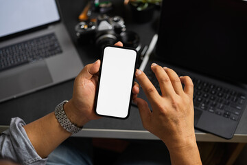 Adult man holding a smartphone blank screen mockup