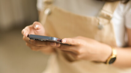 Close-up image of a young girl using modern smartphone.