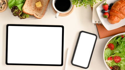 A smartphone and tablet mockup surrounded with healthy food.
