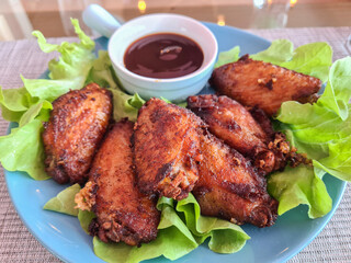 Crispy fried chicken and sauce on wooden table