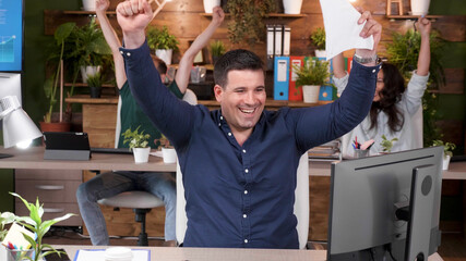 Successful happy businessteam throwing business paperwork in air after finishing management project...