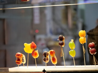 Candies of the travel destinations in Shanghai Chenghuang area. Travel and food concept photo. Traditional Chinese food in the street. Colorful food with the blur background